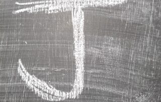 J written in chalk on board
